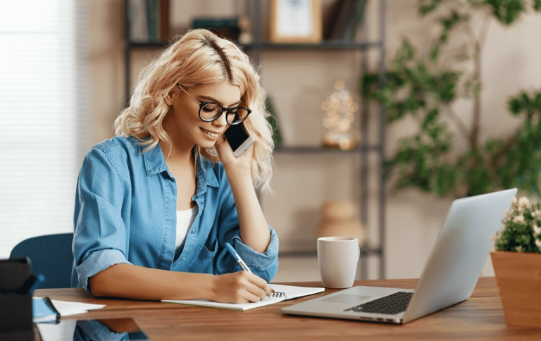 Customer support representative on call with laptop