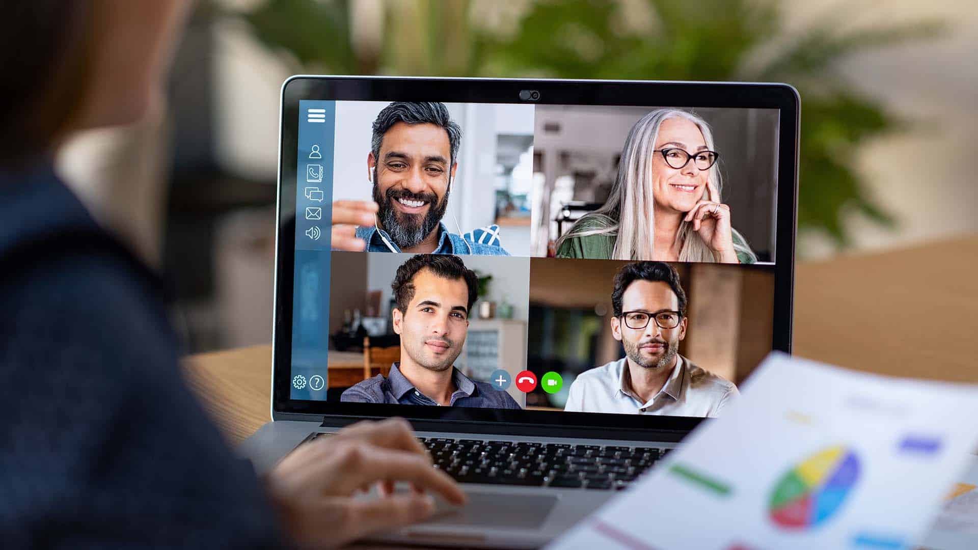 Laptop screen with video conferencing between a remote working team