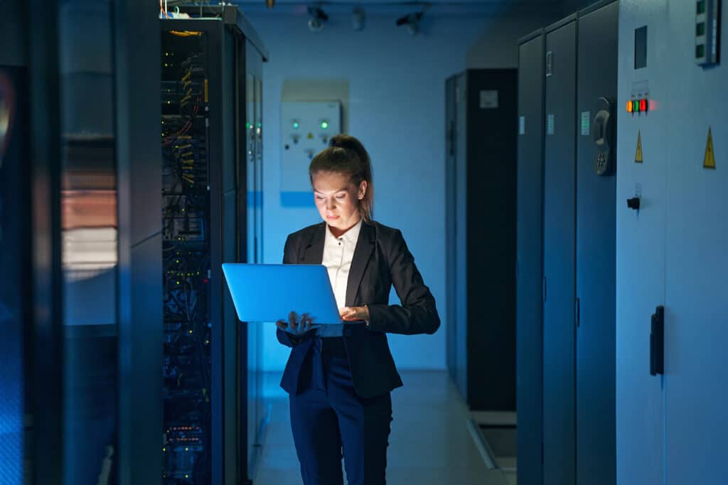 IT engineer in server room configuring cybersecurity solutions