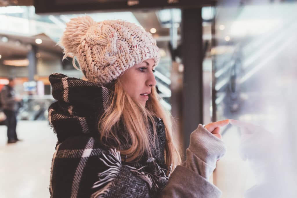 woman using digital signage display